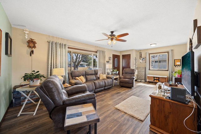 living room featuring dark wood finished floors and ceiling fan