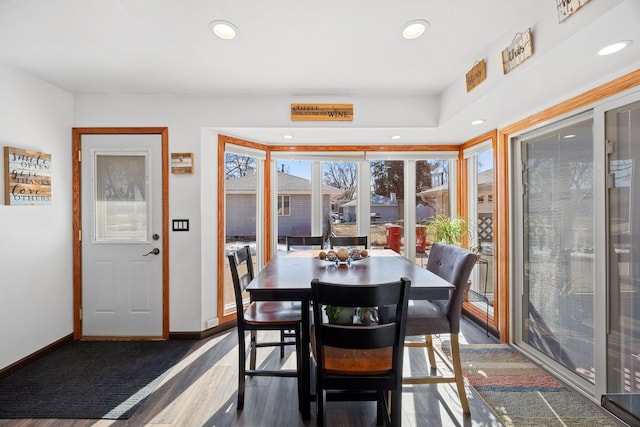 dining area featuring recessed lighting, baseboards, and wood finished floors