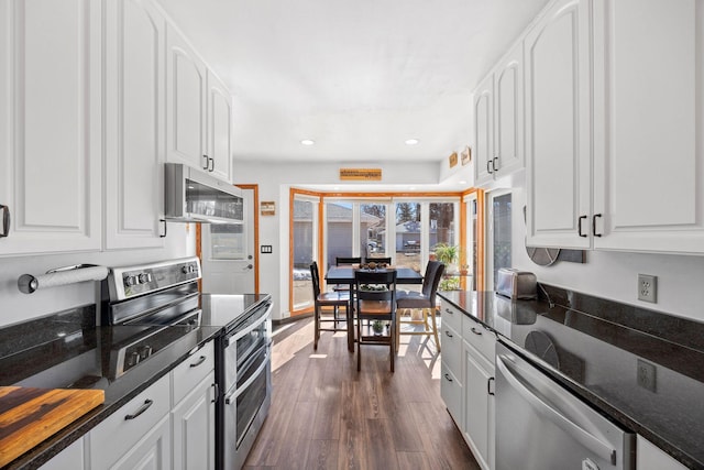 kitchen featuring white cabinetry, stainless steel appliances, and dark wood-type flooring