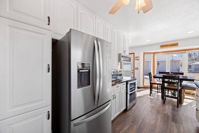 kitchen with dark wood finished floors, white cabinets, recessed lighting, and stainless steel appliances