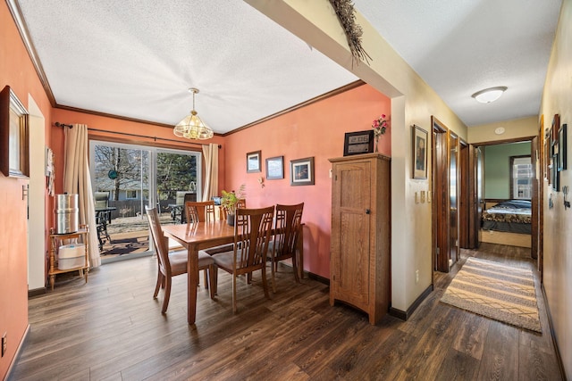 dining space featuring baseboards, dark wood-type flooring, ornamental molding, and a textured ceiling