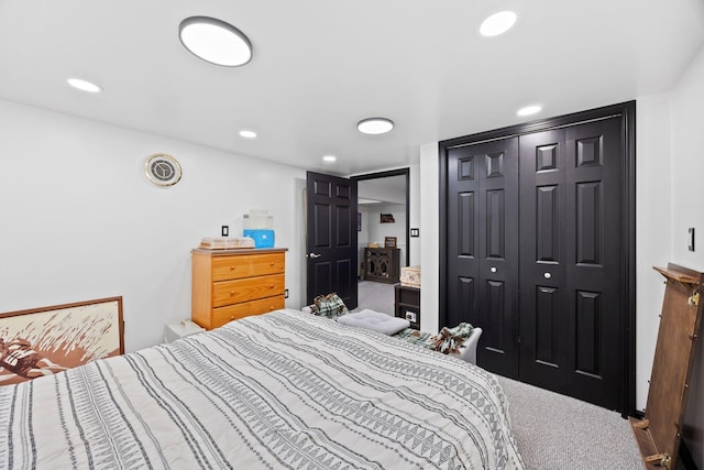 carpeted bedroom with a closet and recessed lighting