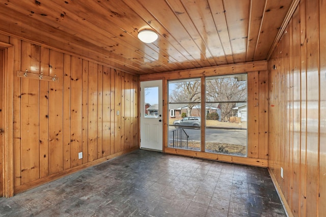 unfurnished room with wood walls and wooden ceiling