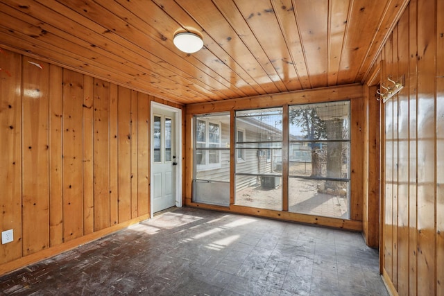 empty room with wooden walls and wood ceiling