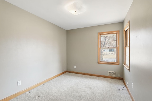 empty room with baseboards and carpet floors