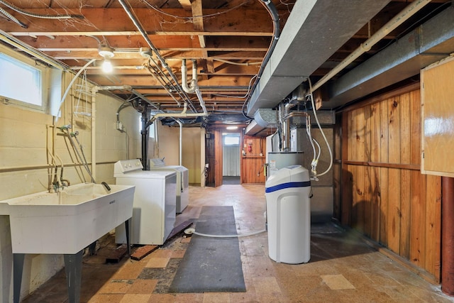 below grade area featuring a sink and washing machine and clothes dryer