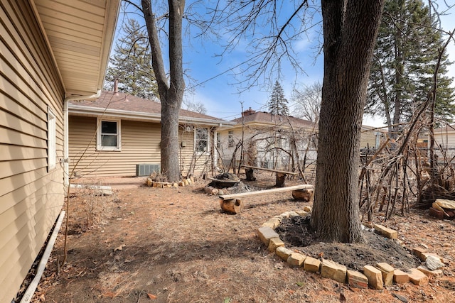 back of property with central air condition unit and fence