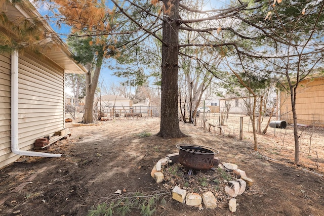 view of yard featuring a fire pit and a fenced backyard