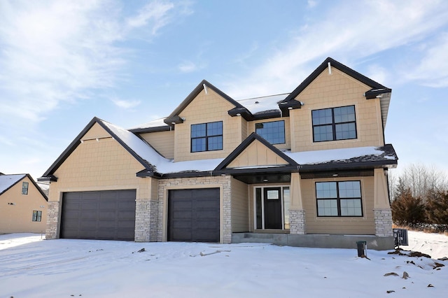 view of front of home featuring stone siding, board and batten siding, and a garage