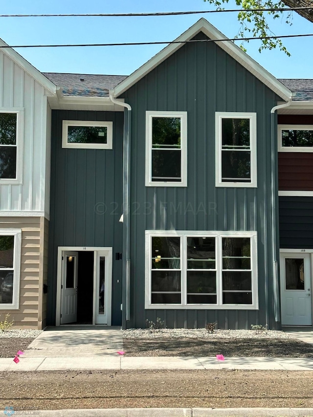 view of front of home with board and batten siding and a shingled roof