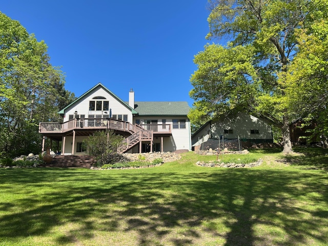 568 State Highway 6 NE, Outing, MN 56662 - back of property with stairway, a deck, a chimney, and a yard