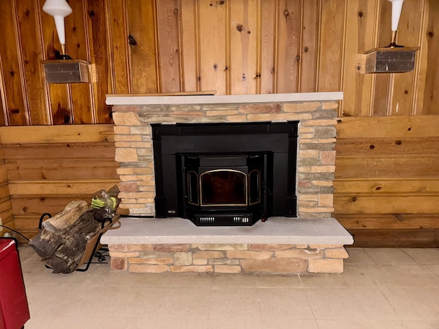 interior details with wooden walls and a wood stove