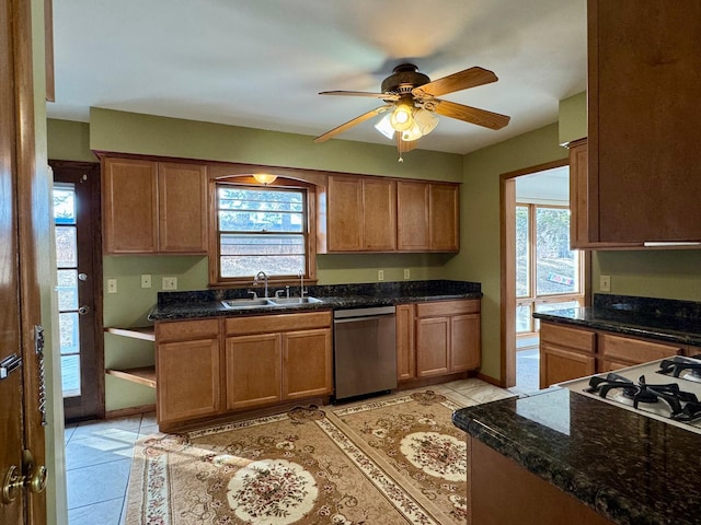 kitchen with a sink, plenty of natural light, dishwasher, and light tile patterned floors