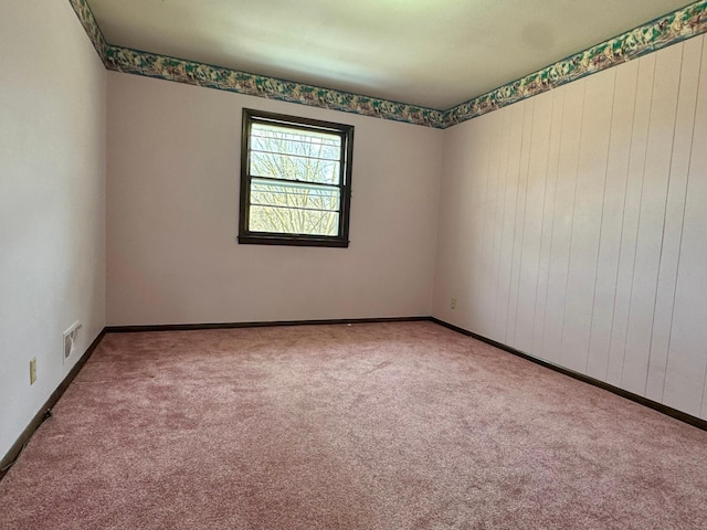 carpeted empty room with visible vents and baseboards