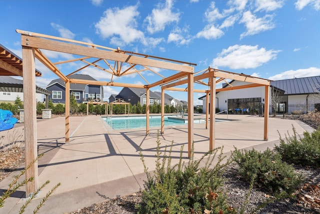 outdoor pool with a residential view and a patio