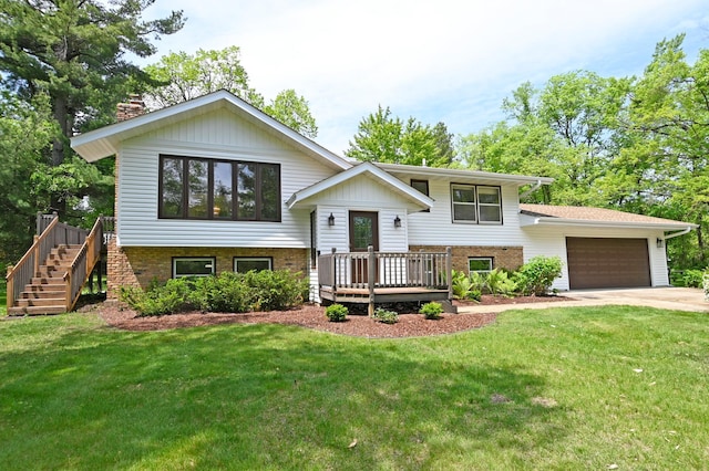 21414 Tulip St NW, Oak Grove, MN 55303 - bi-level home with brick siding, a garage, a chimney, a front yard, and driveway