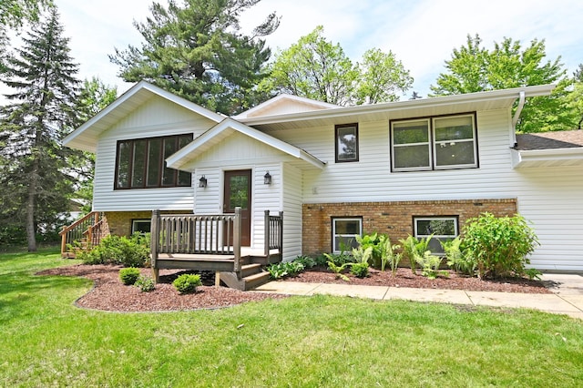 21414 Tulip St NW, Oak Grove, MN 55303 - raised ranch featuring brick siding, a front lawn, and a deck
