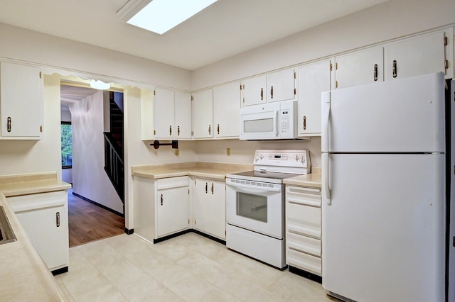 21414 Tulip St NW, Oak Grove, MN 55303 - kitchen featuring white appliances, light countertops, and white cabinetry