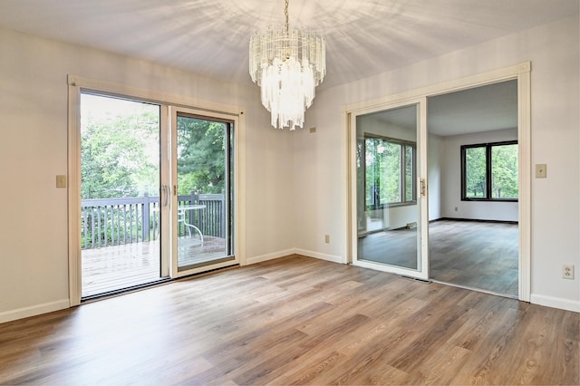 21414 Tulip St NW, Oak Grove, MN 55303 - unfurnished room with a chandelier and wood finished floors