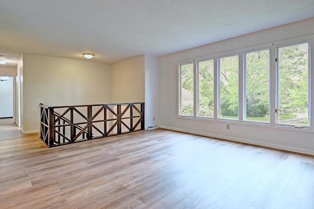 21414 Tulip St NW, Oak Grove, MN 55303 - spare room featuring baseboards and wood finished floors