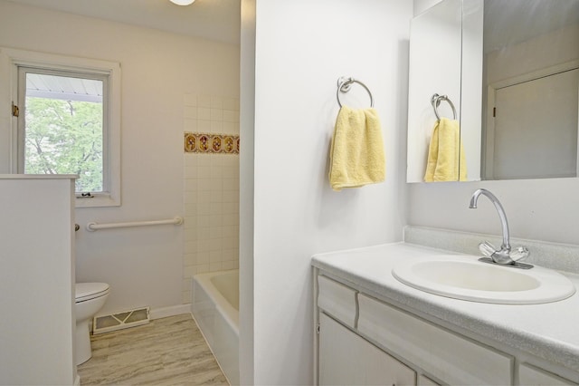 21414 Tulip St NW, Oak Grove, MN 55303 - bathroom with vanity, wood finished floors, and shower / tub combination