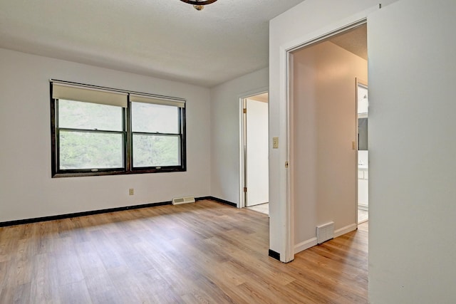 21414 Tulip St NW, Oak Grove, MN 55303 - unfurnished room with light wood finished floors and baseboards