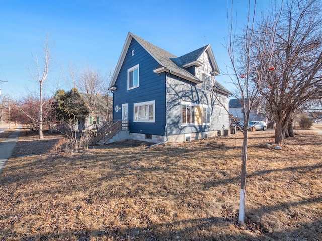 view of side of property with a shingled roof