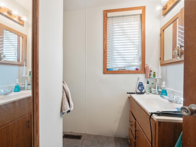 bathroom featuring visible vents, vanity, and tile patterned flooring