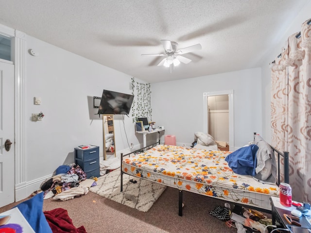 bedroom featuring ceiling fan, carpet floors, and a textured ceiling