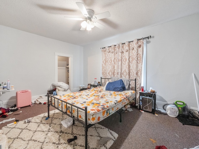 carpeted bedroom with ceiling fan, baseboards, and a textured ceiling