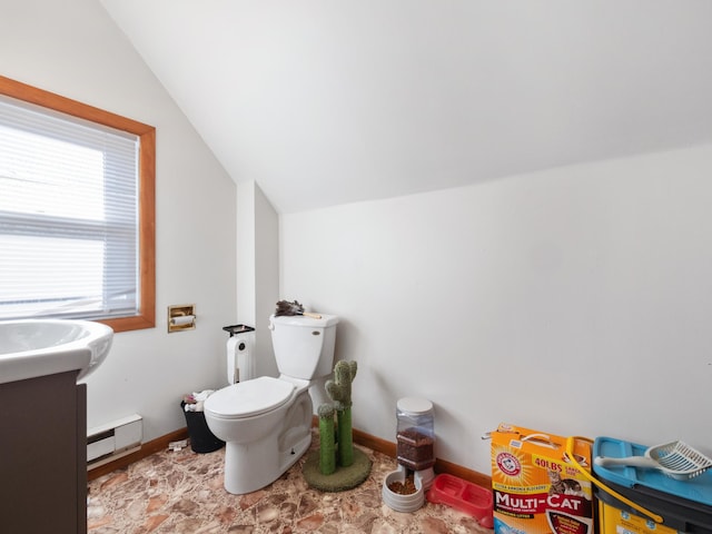 half bath featuring a baseboard heating unit, lofted ceiling, toilet, and baseboards