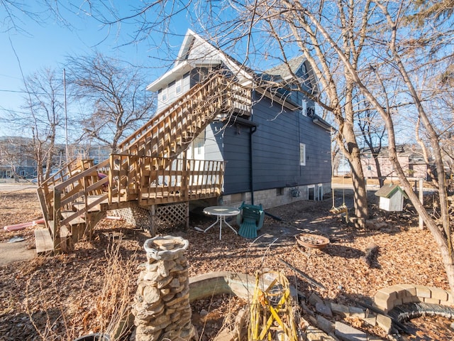 rear view of house with stairway and a deck