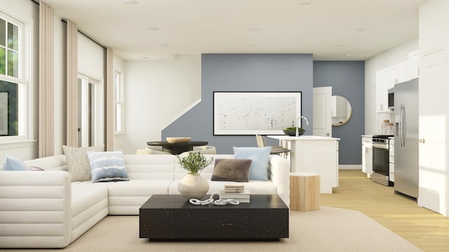 living area with plenty of natural light and light wood finished floors