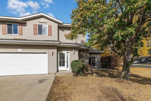 view of front of property featuring concrete driveway and a garage