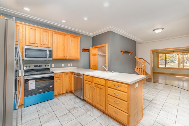 kitchen with a sink, recessed lighting, stainless steel appliances, a peninsula, and light countertops