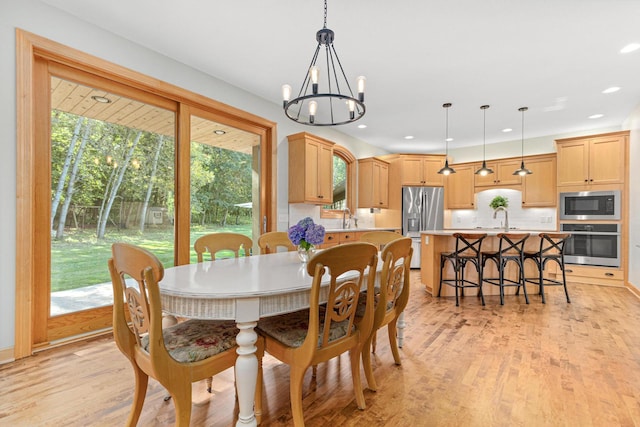 dining room featuring a notable chandelier, recessed lighting, and light wood-type flooring