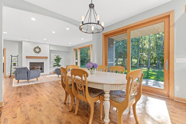 dining area featuring a wealth of natural light, light wood-style floors, recessed lighting, and a fireplace