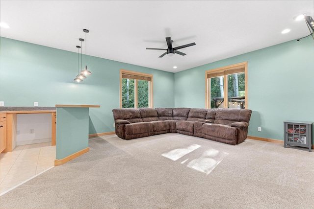 living room with ceiling fan, recessed lighting, baseboards, and light carpet