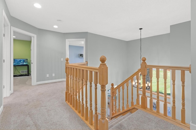 hallway with an upstairs landing, carpet flooring, recessed lighting, and baseboards