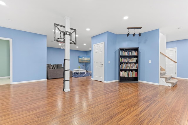 living room with stairway, recessed lighting, wood finished floors, and baseboards