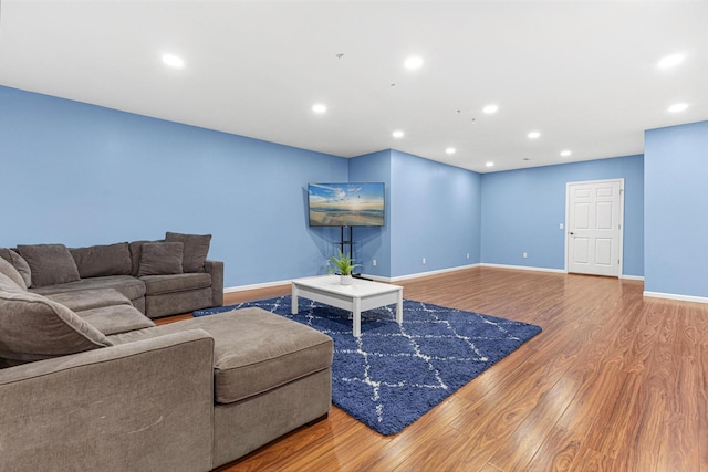 living area featuring recessed lighting, wood finished floors, and baseboards