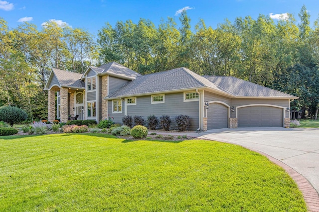 view of front of property featuring driveway, a shingled roof, a front lawn, a garage, and stone siding