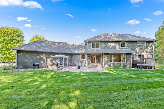 rear view of property with a yard and a patio