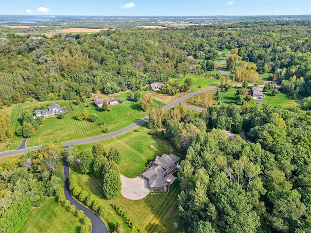 birds eye view of property featuring a wooded view