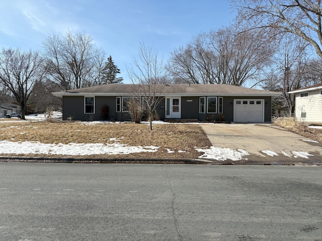 ranch-style house with concrete driveway and a garage