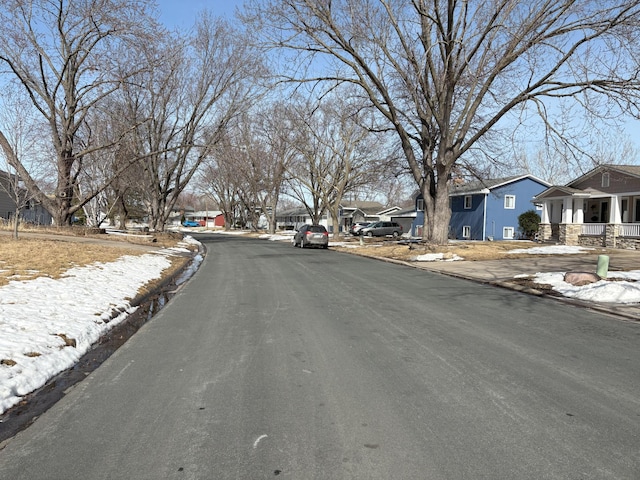 view of street with a residential view and curbs