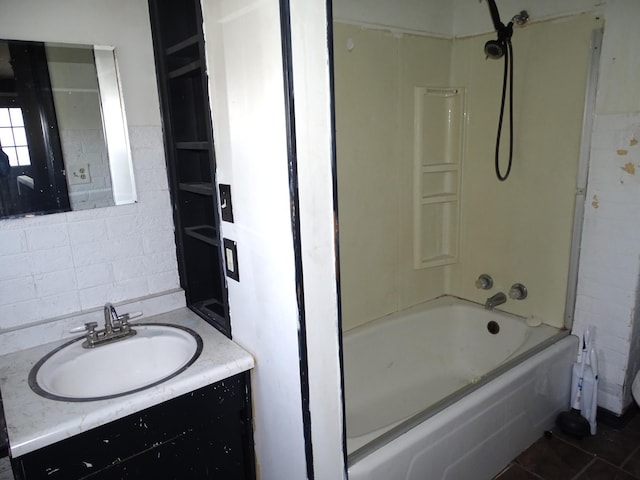 full bathroom with tile patterned floors, vanity, tile walls, and shower / tub combination