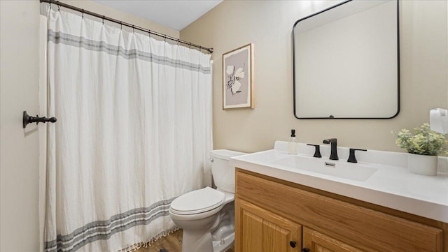 bathroom with vanity, a shower with shower curtain, and toilet