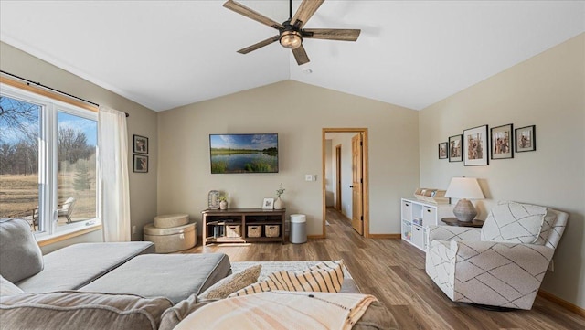 living room featuring ceiling fan, a healthy amount of sunlight, wood finished floors, and vaulted ceiling