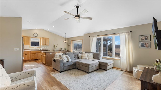 living room with ceiling fan, lofted ceiling, light wood-style flooring, and recessed lighting